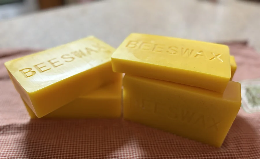 Blocks of our rendered beeswax, each stamped BEESWAX